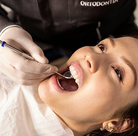 Close up of dentist examining woman’s mouth