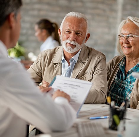 Senior couple filling out paperwork